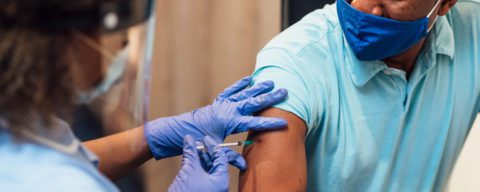 Person getting vaccine shot 5x2