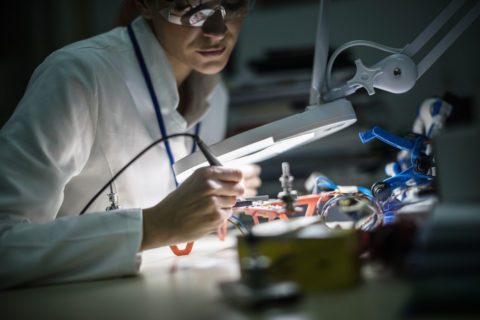 Female electrician working on drone