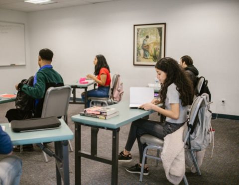 Community college students studying in classroom