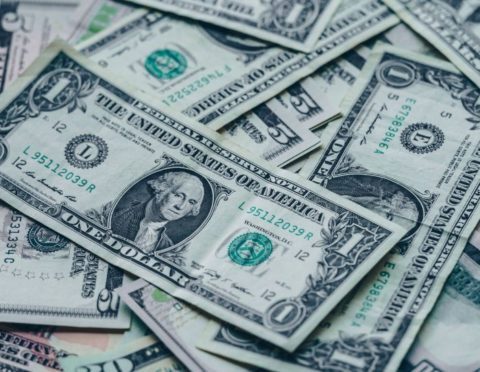 Scattered one dollar and five dollar bills