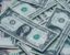 Scattered one dollar and five dollar bills