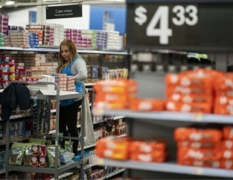 A worker organizes items at a Walmart supercenter.