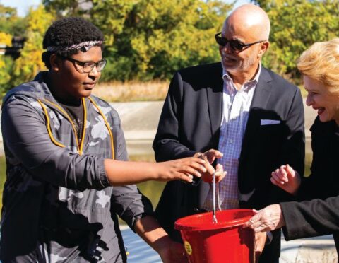 Wayne County Executive Warren C. Evans and Senator Debbie Stabenow attend a community fishing event.