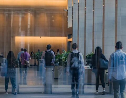 Employees walking into an office building