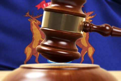 Wood Gavel Standing Front Of the Michigan Flag Closeup 3d Render
