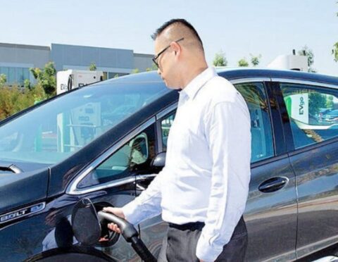 A man using an EV charging station