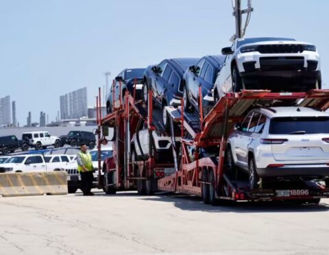 A transport carrying new cars arrives at a Stellantis facility on Monday, July 10, 2023, in Belvidere. Ill.