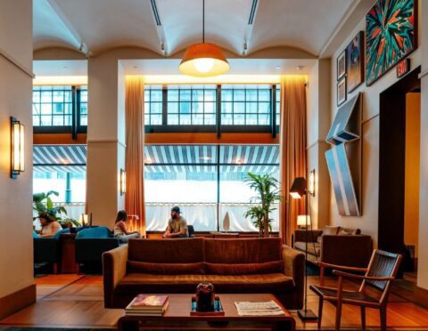 People sit in the lobby of the Shinola Hotel in Downtown Detroit on July 8, 2023.