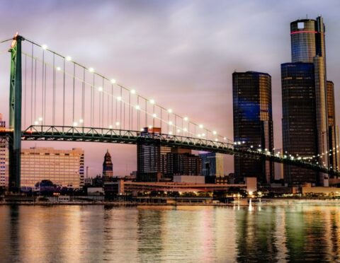 The Detroit skyline as seen from across the Detroit River, in Windsor, Ontario, Canada. The two cities are linked by the Ambassador Bridge.