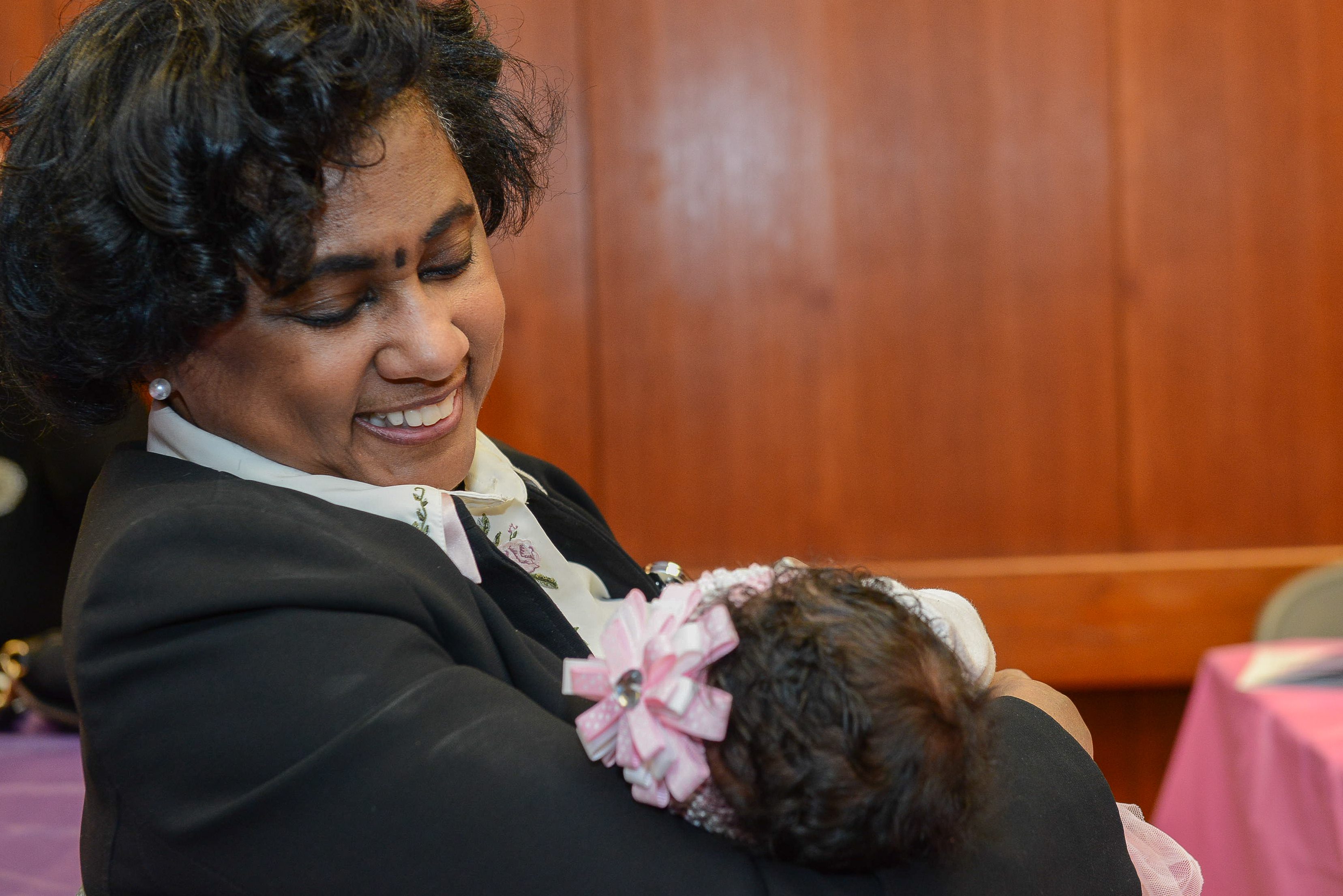 Dr. Kimberlydawn Wisdom holding a child