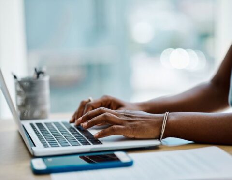 a close up of a woman using a computer