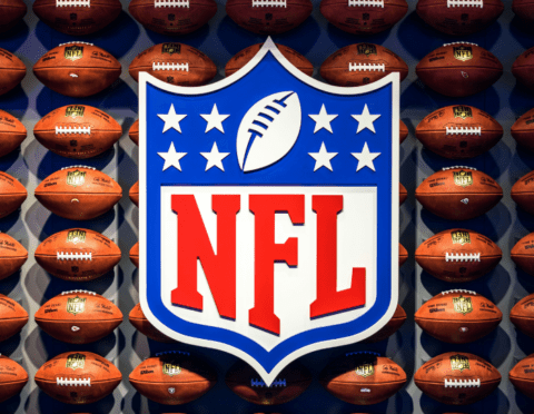 NFL logo on backdrop of footballs