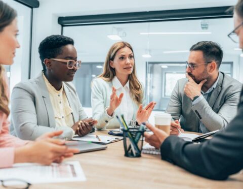 a diverse group of employees having a meeting in an office