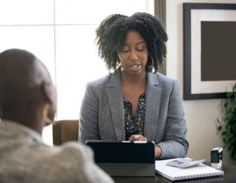 Two Black women talk about finances.