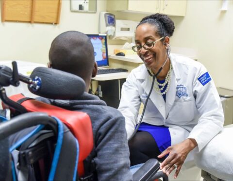 A doctor smiling with a patient