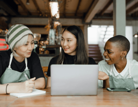 group of small business employees reviewing the SBAM Wellness Program on a laptop