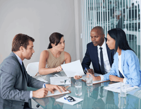 analysis paralysis - business leaders and anxiety - small group of individuals looking over paperwork - featured web