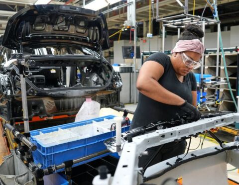 A woman working on a car