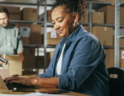 Male and Female Warehouse Inventory Managers Talking