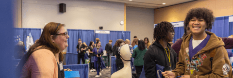 Boy speaking with a health care professional at the 2026 Health Careers Expo
