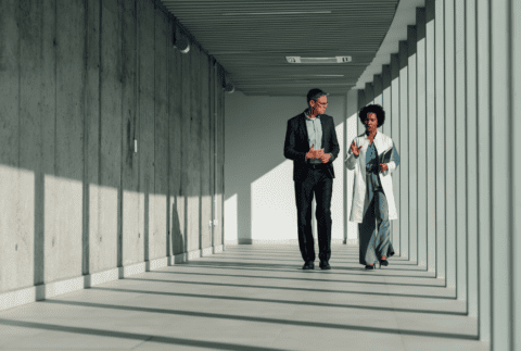 Hospital executives walking down a hallway and talking