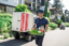A smiling man in a hat delivering fresh produce