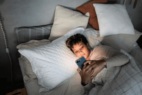 a woman on her phone in bed