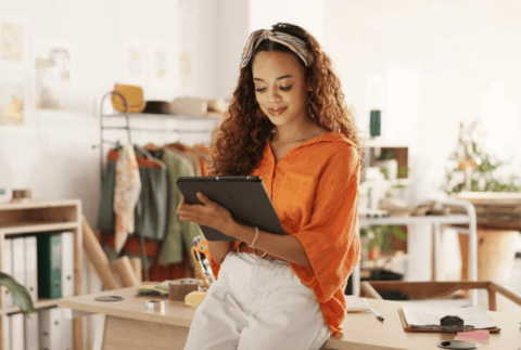 woman smiling and holding a tablet