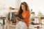 woman smiling and holding a tablet