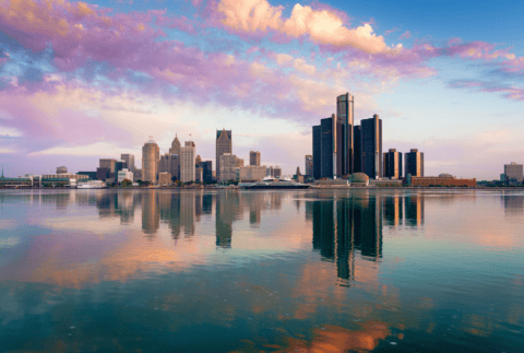 Detroit, Michigan, USA skyline on the Detroit River at dawn.