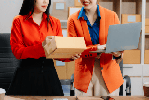 Starting small businesses SME owners, two check online orders Selling products working with boxes freelance work at home office.